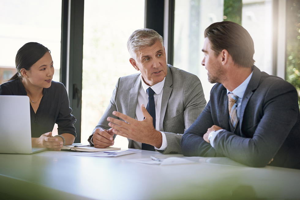 team of businesspeople meeting at a table in a boardroom