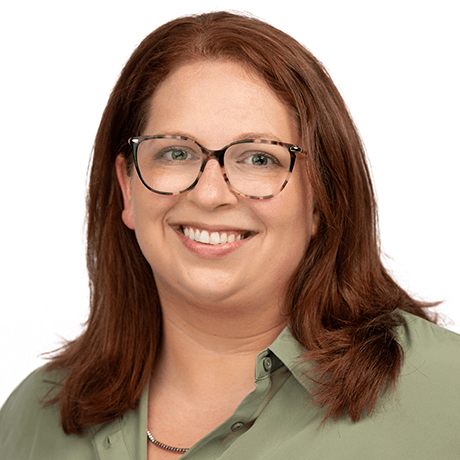 Headshot of Allison Digilio who is a Business Development Coordinator from Pennsylvania. She has reddish-brown hair, glasses and is wearing a green button up.